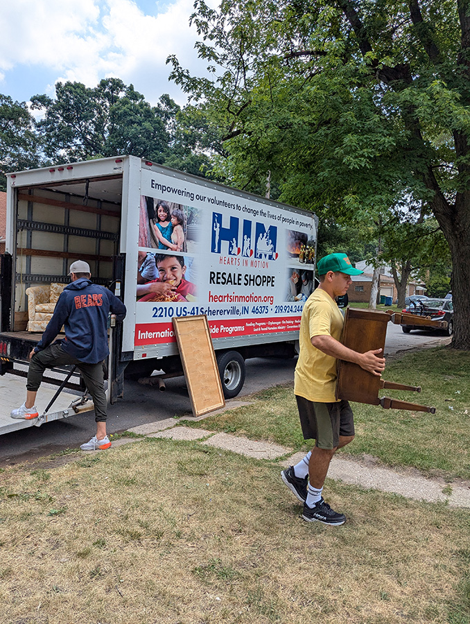 Moving furniture into a newly furnished apartment that was furnished by the New Directions Program.