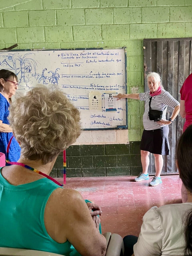 Vision clinic reading charts with patients