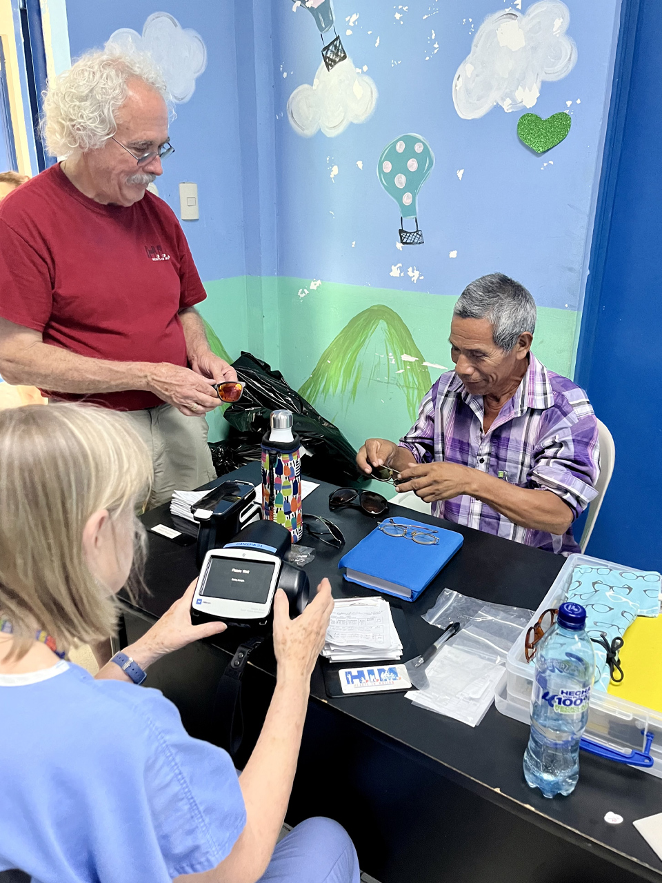 Marcia McGinnis and Steve Roche providing vision care to a patient at a pop up vision clinic Guatemala.