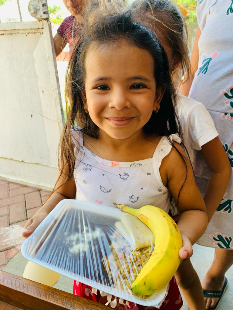 Sponsorship child receiving her food at the weekly feed program at the HIM nutrition center in Gualan, Guatemala.