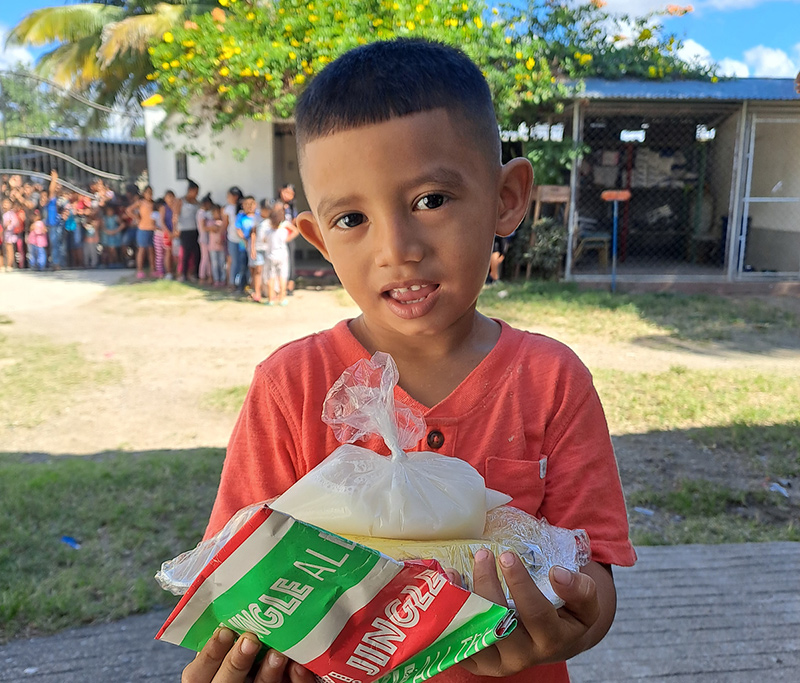 Sponsorship child getting their food at the weekly feed program at the HIM nutrition center in Gualan, Guatemala.