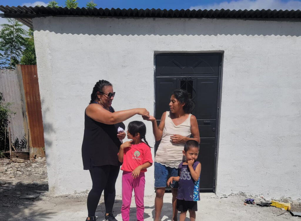 Family receiving keys to their newly built home in Pueblo Modelo, Guatemala built and funded by Hearts In Motion