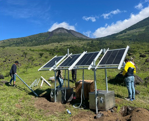 Geoscientists without borders setting up solar panels for a project on the Pacaya Volcano.